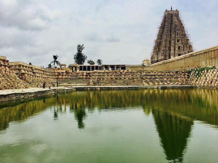 historical temple by lake against sky 1048944 23349495