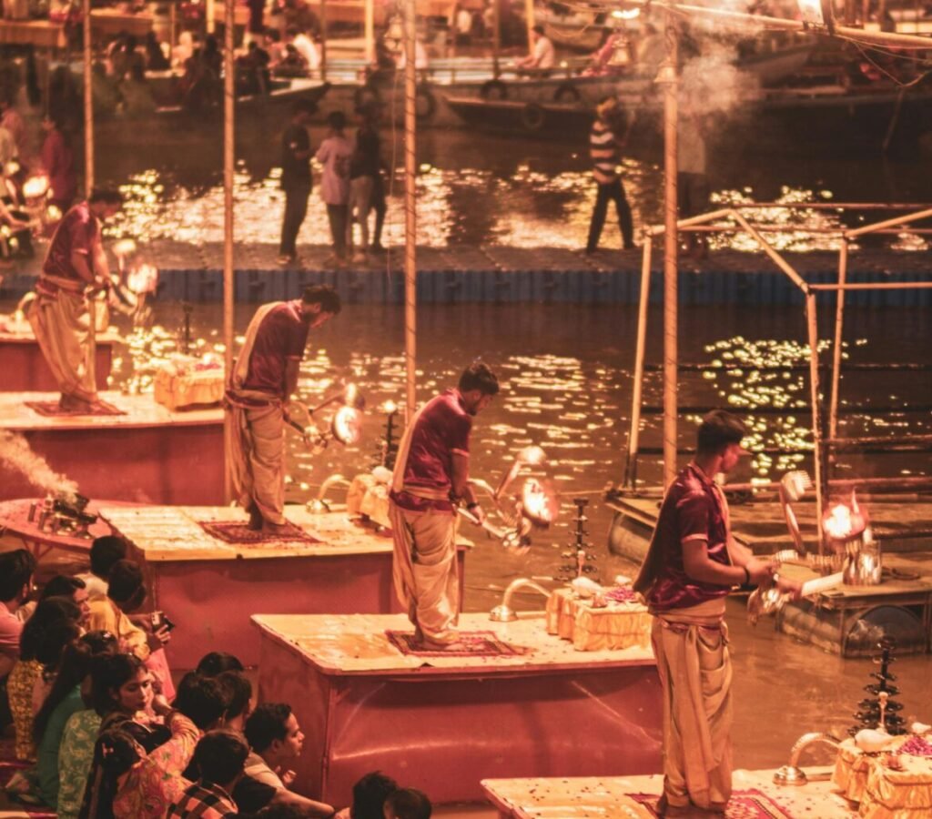 Evening Ganga Aarti ceremony with worshippers on the banks of the Ganges in Varanasi, India.
