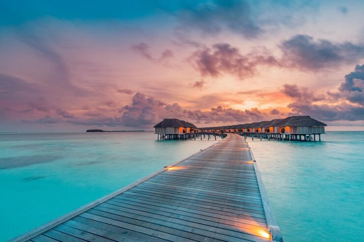 sunset maldives water villas with golden sky clouds calm ocean tranquil tropical ambiance 663265 10279