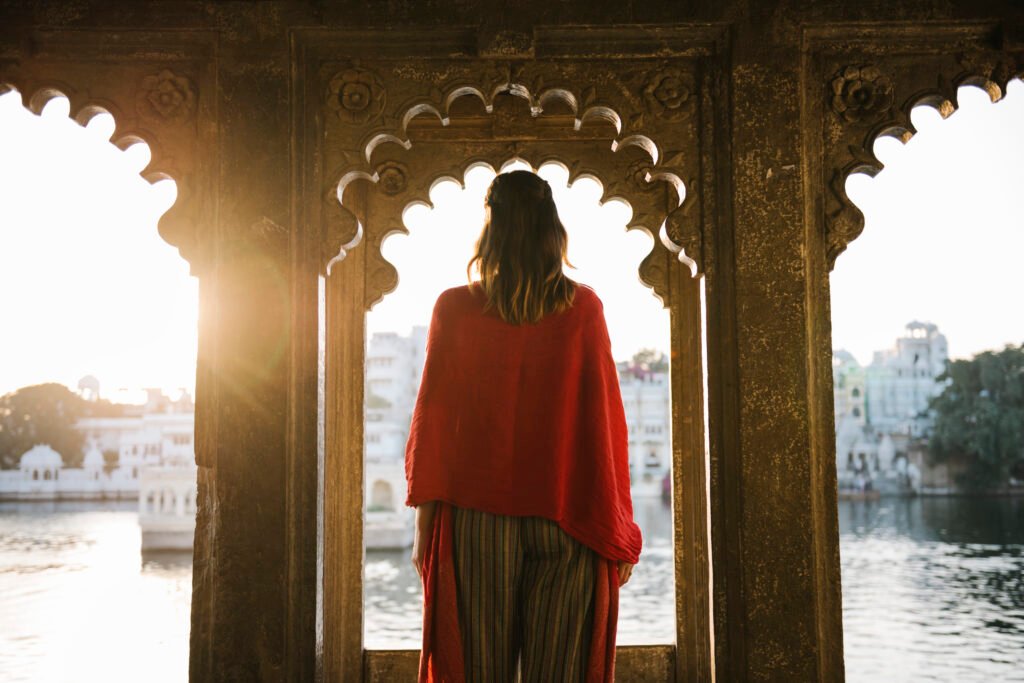 western woman standing on a cultural architecture in udaipur, india