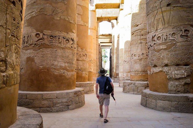 young man walking egyptian temple 181624 44493